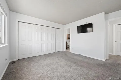 a view of an empty room with entryway and stairs