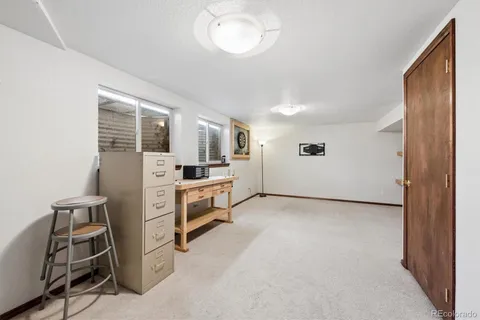 a view of workspace with furniture and window