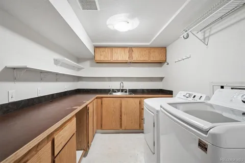 a kitchen with a sink cabinets and window