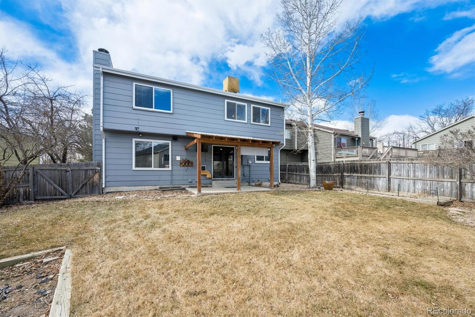 9802 Garrison Court Westminster, CO 80021 - Photo 31 of 34 a house with yard in front of it