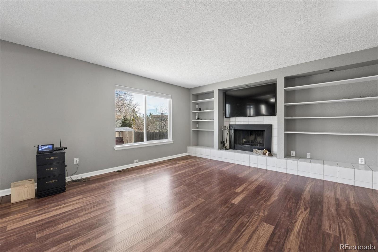 9802 Garrison Court Westminster, CO 80021 - Photo 5 of 34 a view of an empty room with wooden floor and a window