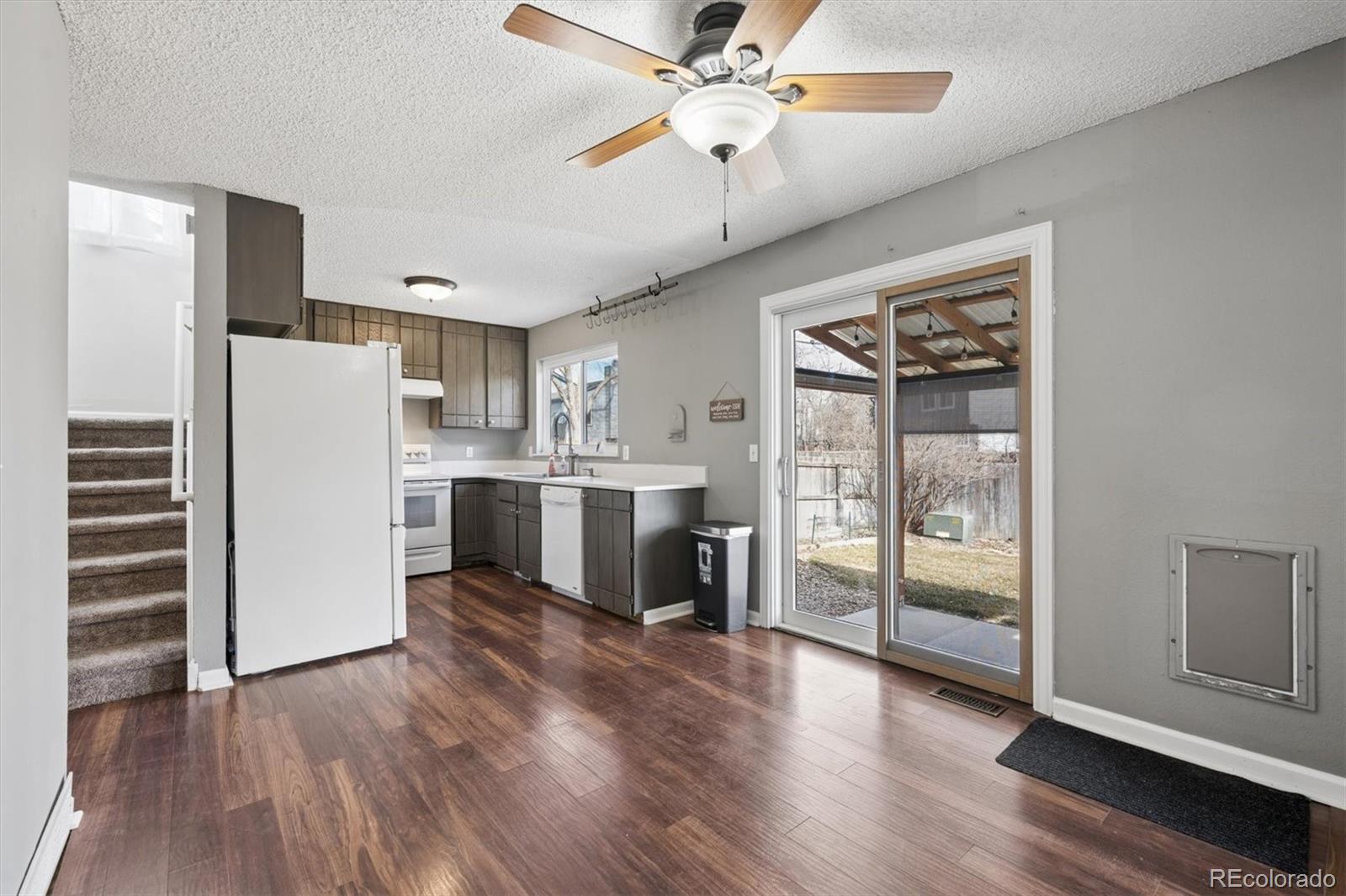 9802 Garrison Court Westminster, CO 80021 - Photo 10 of 34 a kitchen with stainless steel appliances a refrigerator and a stove top oven
