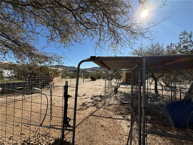 a view of a yard with wooden fence