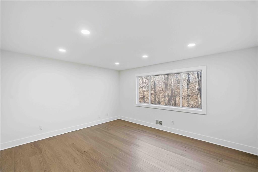 8975 Martin Road Roswell, GA 30076 - Photo 11 of 32 an empty room with wooden floor and windows