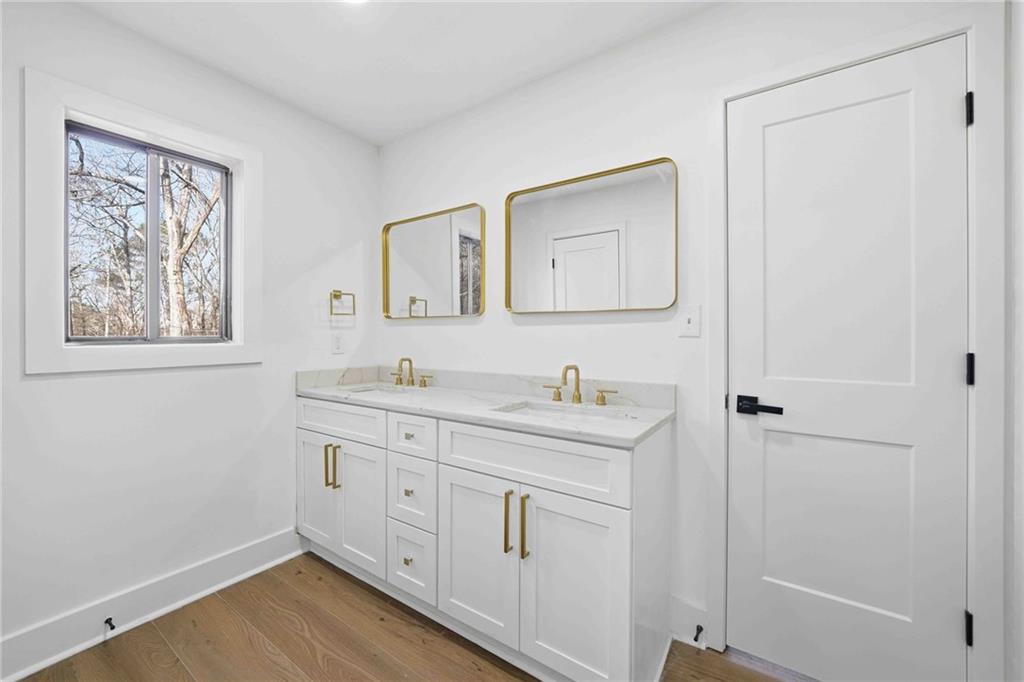 8975 Martin Road Roswell, GA 30076 - Photo 12 of 32 a spacious bathroom with 2 sink toilet and a mirror