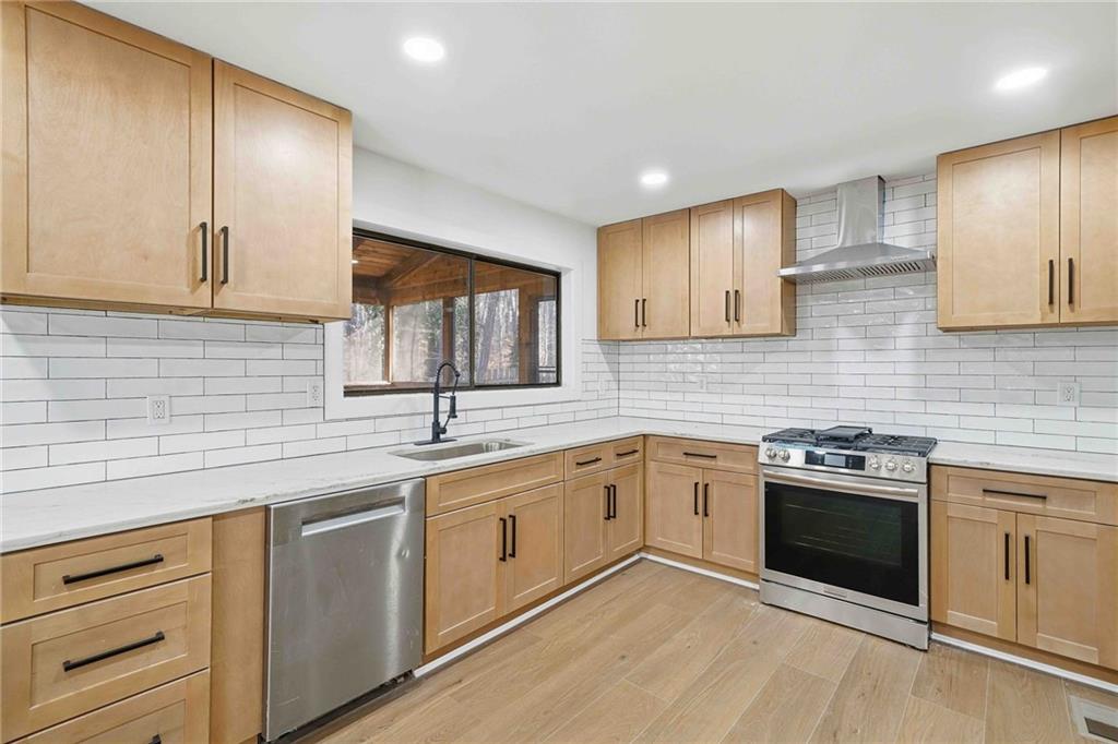 8975 Martin Road Roswell, GA 30076 - Photo 2 of 32 a kitchen with a sink stove and cabinets