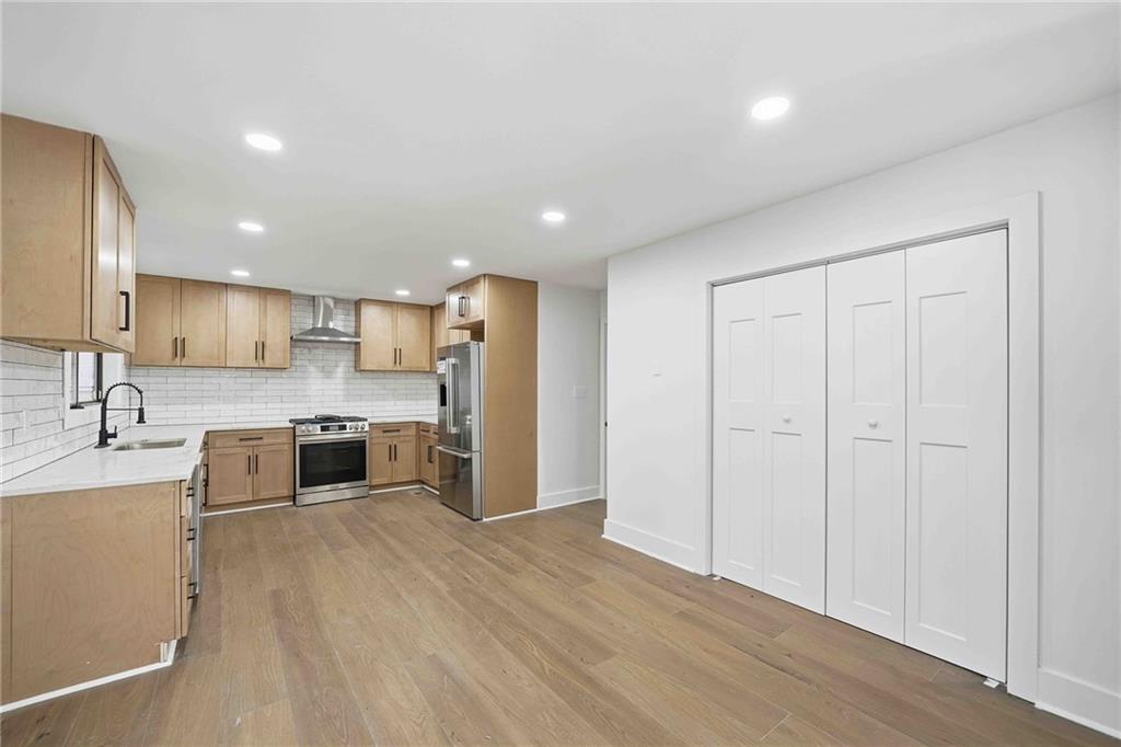 8975 Martin Road Roswell, GA 30076 - Photo 5 of 32 a large kitchen with stainless steel appliances granite countertop a large counter top a sink and a stove
