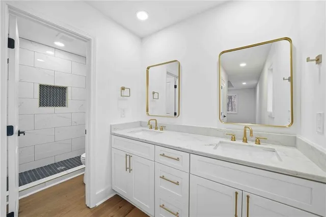 a bathroom with double sink and a mirror