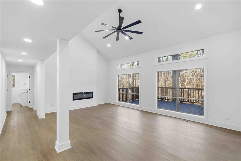 8975 Martin Road Roswell, GA 30076 - Photo 7 of 32 a view of an empty room with a window and wooden floor