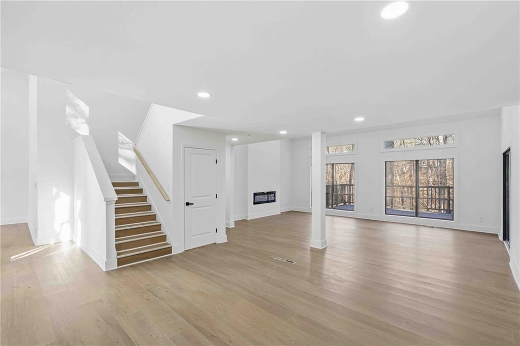 8975 Martin Road Roswell, GA 30076 - Photo 10 of 32 a view of an empty room with wooden floor and stairs