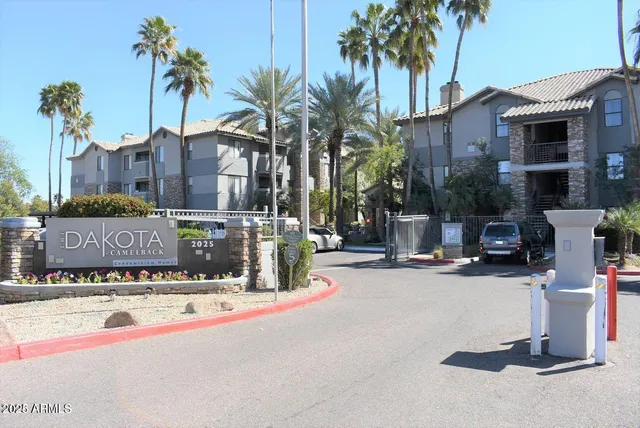 a street sign on a wall next to a building