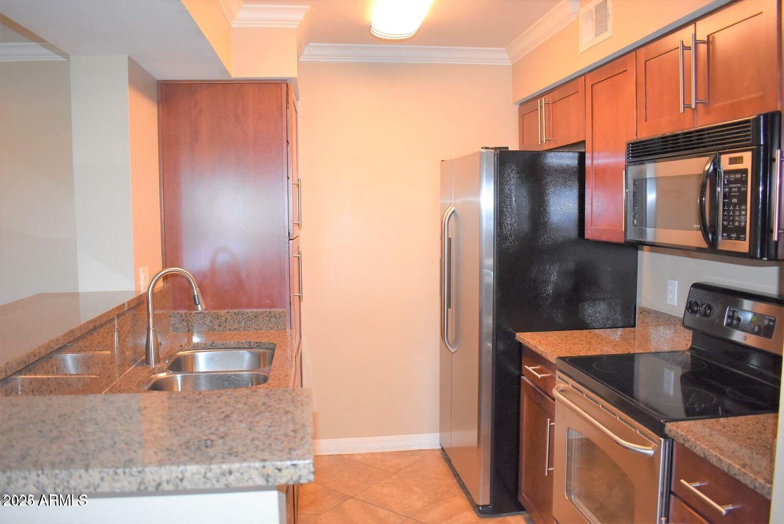 2023 East Campbell Avenue, Unit 331 Phoenix, AZ 85016 - Photo 4 of 18 a kitchen with stainless steel appliances granite countertop a sink stove and refrigerator