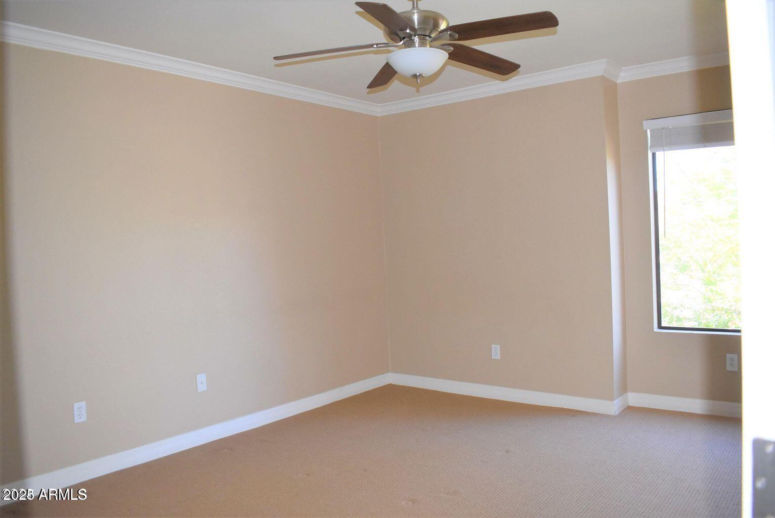 2023 East Campbell Avenue, Unit 331 Phoenix, AZ 85016 - Photo 8 of 18 an empty room with a window and a fan