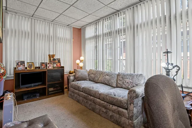 a living room with furniture and a floor to ceiling window