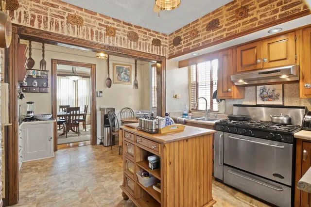 a kitchen that has a stove and a table