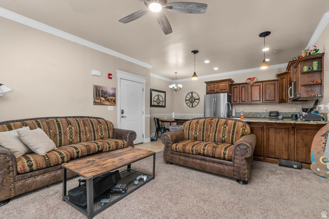 476 West 200 N Street, Unit 206 Springville, UT 84663 - Photo 4 of 24 Living room featuring crown molding, ceiling fan, hanging lights, and light carpet