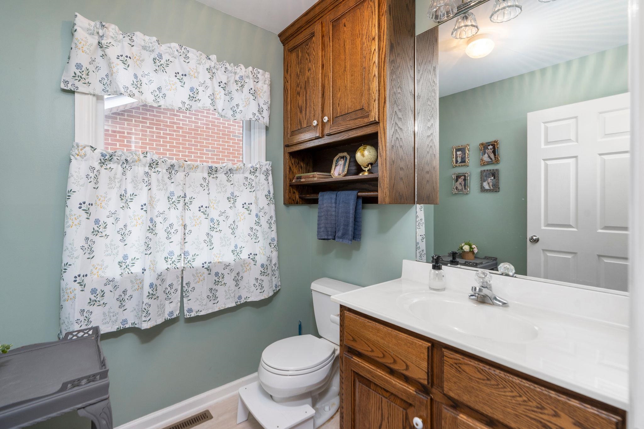 1197 Entry School Road Fishersville, VA 22939 - Photo 34 of 40 a bathroom with a toilet sink and mirror