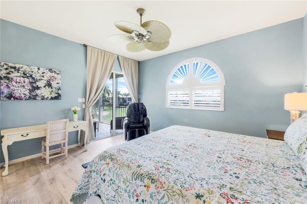 11384 Quail Village Way, Unit 203 Naples, FL 34119 - Photo 18 of 48 a bedroom with a bed and a window