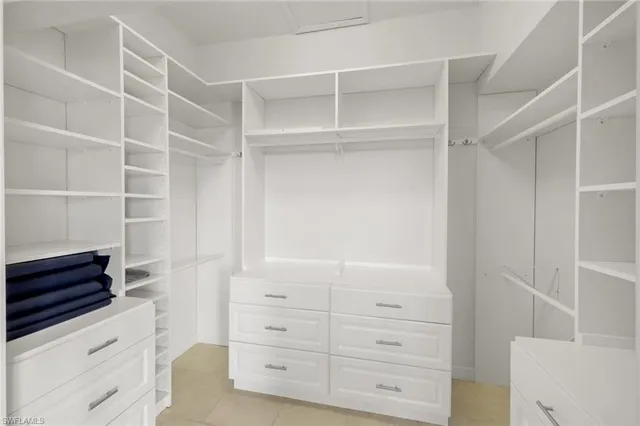 a bathroom with a granite countertop double vanity sink and a mirror