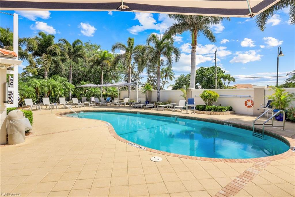 11384 Quail Village Way, Unit 203 Naples, FL 34119 - Photo 37 of 48 swimming pool view with outdoor seating