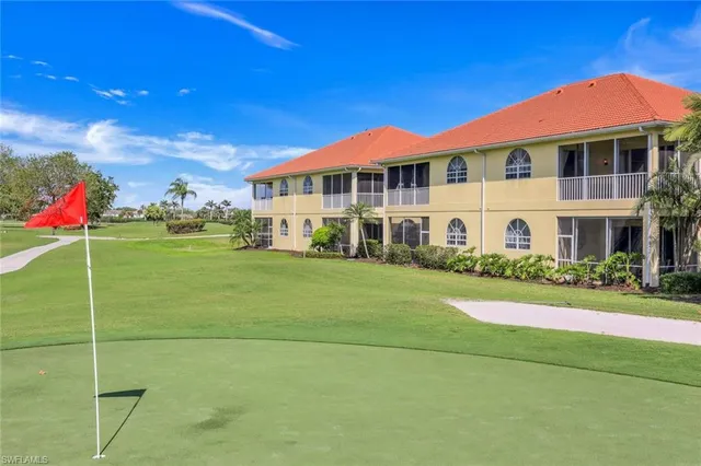 a front view of a building with a garden