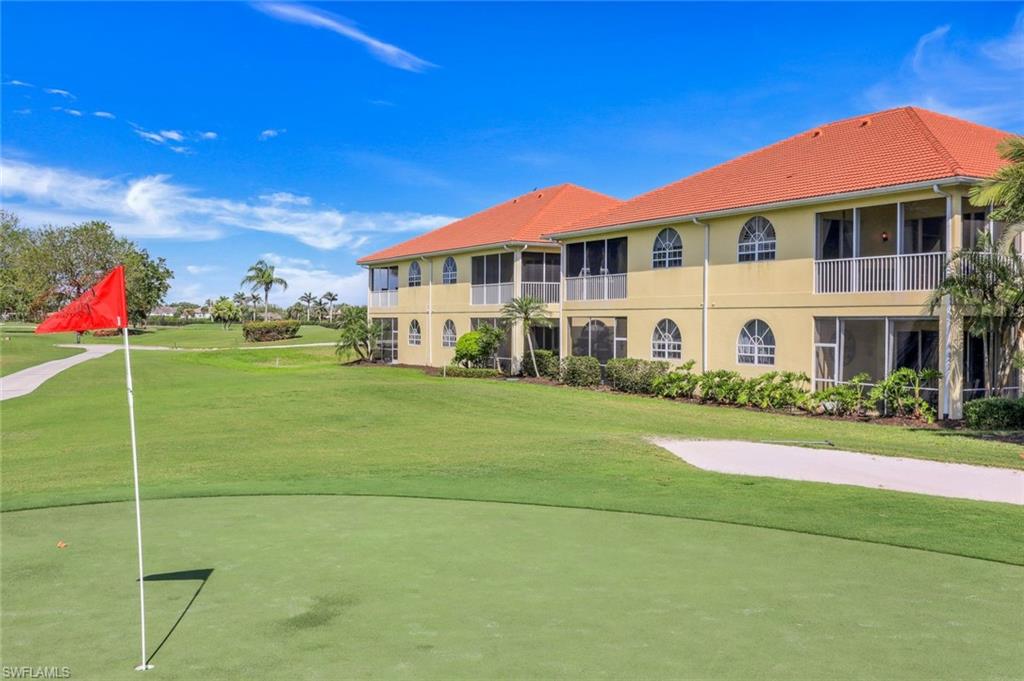 11384 Quail Village Way, Unit 203 Naples, FL 34119 - Photo 5 of 48 a front view of a building with a garden