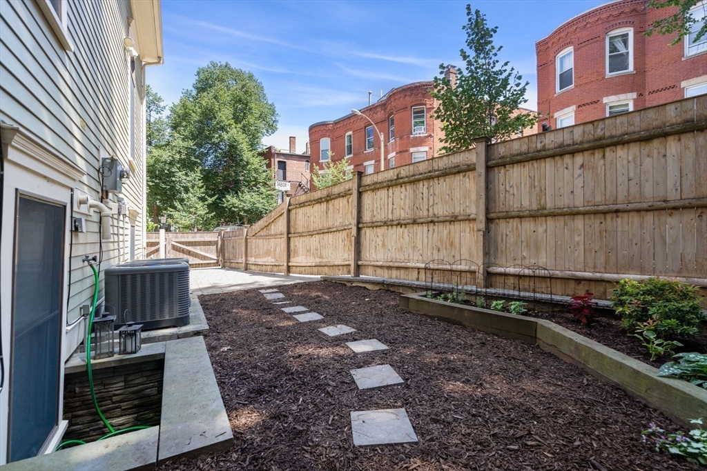 2 Tabor Place Brookline, MA 02445 - Photo 30 of 30 a view of a backyard with plants and a bench
