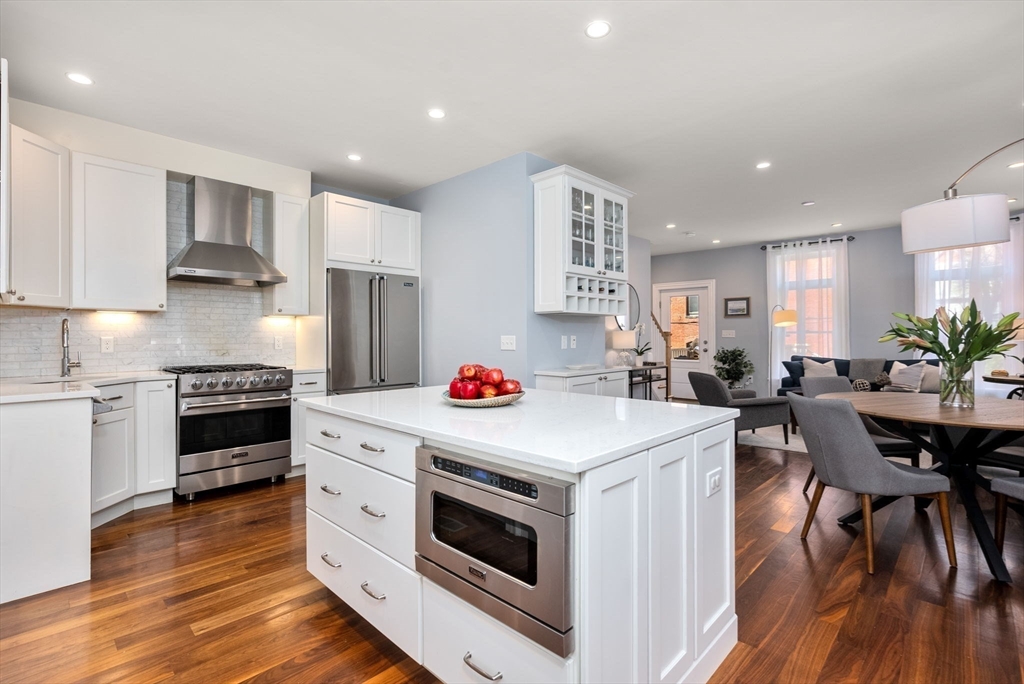 2 Tabor Place Brookline, MA 02445 - Photo 7 of 30 a kitchen that has a lot of white cabinets and stainless steel appliances