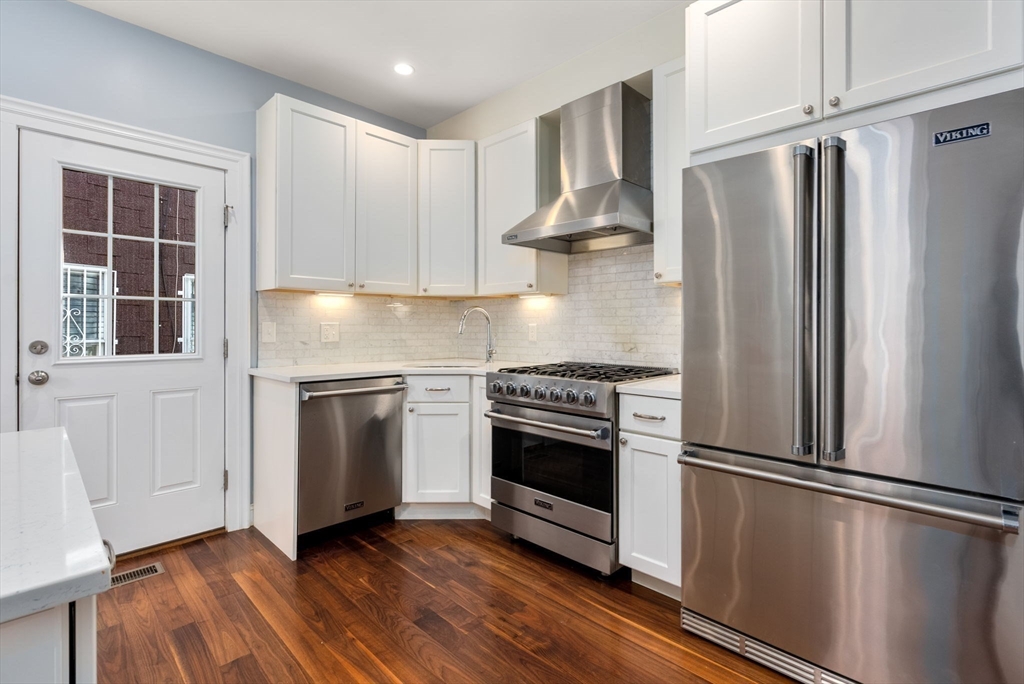 2 Tabor Place Brookline, MA 02445 - Photo 9 of 30 a kitchen with a refrigerator stove and wooden cabinets