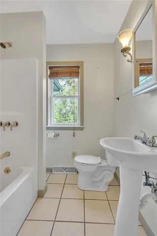 a bathroom with a sink a toilet and bathtub