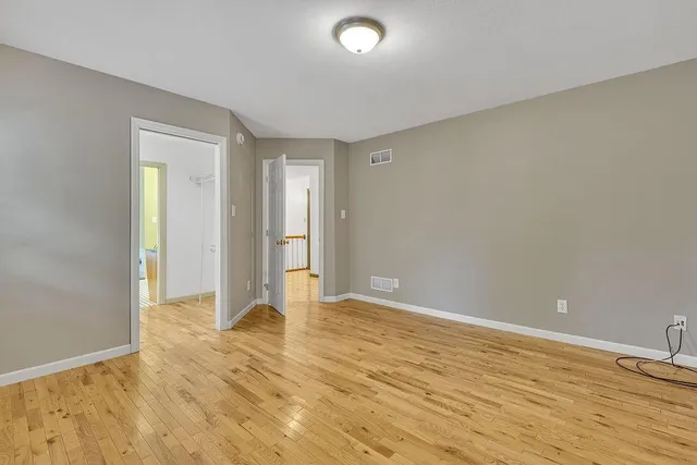 a view of walk in closet with wooden floor