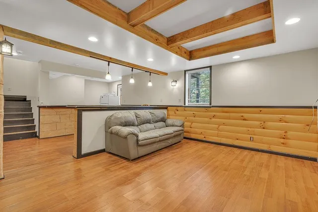 a room with pool table and windows