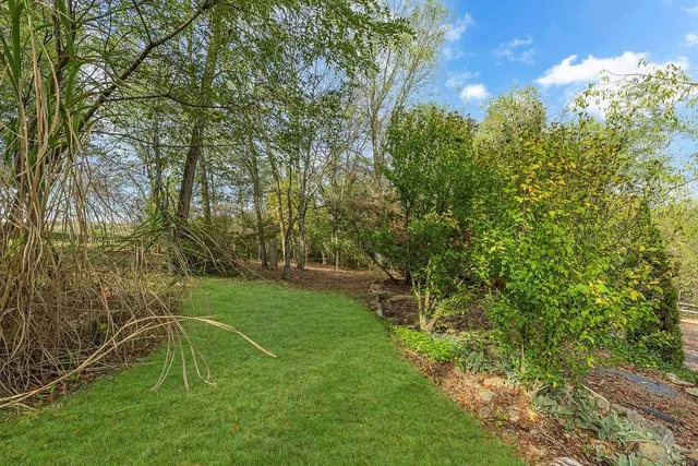 a view of a house with a yard and garage