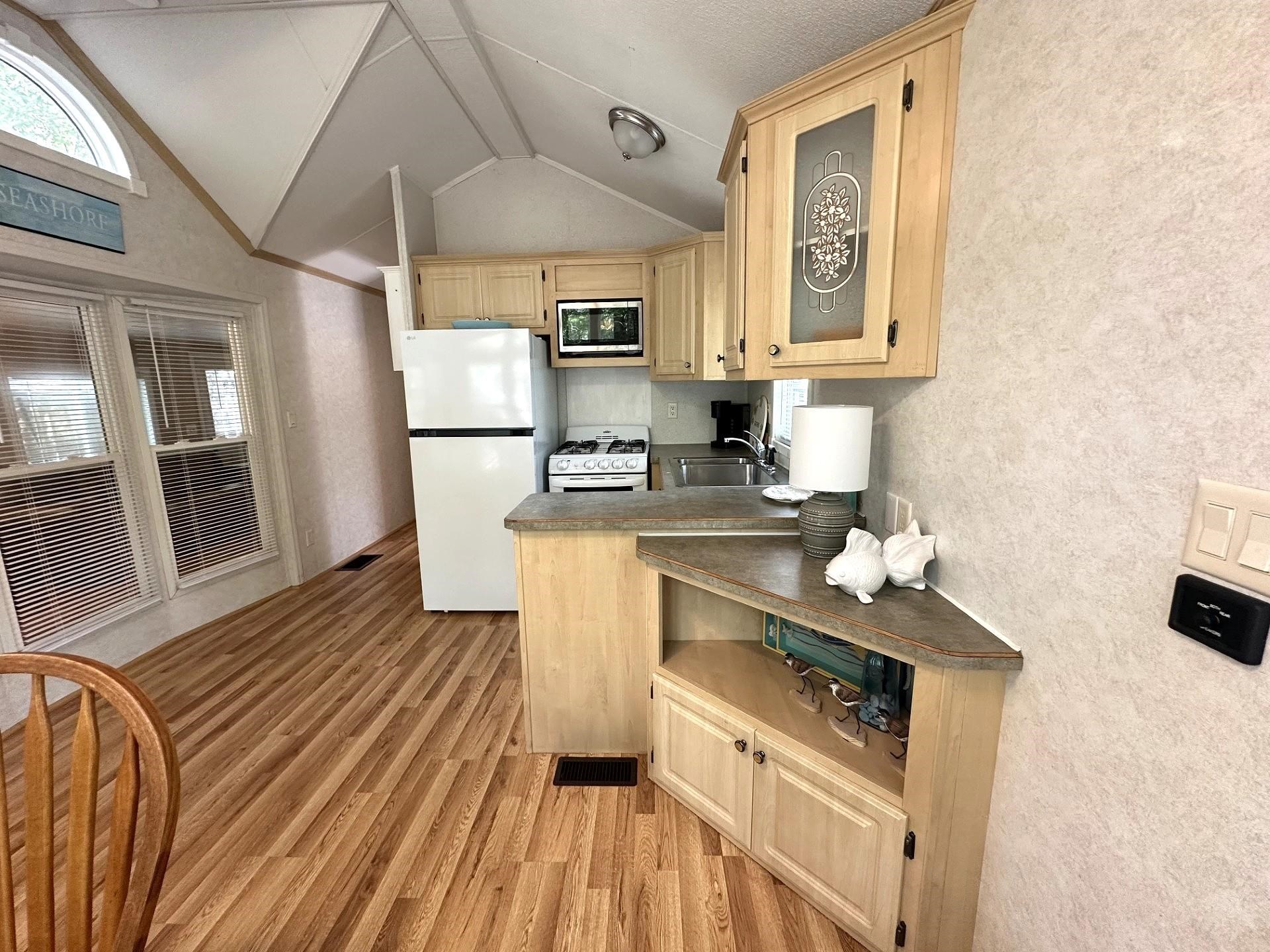 3066 North Rte 9 Ocean View, NJ 08230 - Photo 18 of 49 a kitchen with stainless steel appliances a stove a sink dishwasher a refrigerator with white cabinets and wooden floor