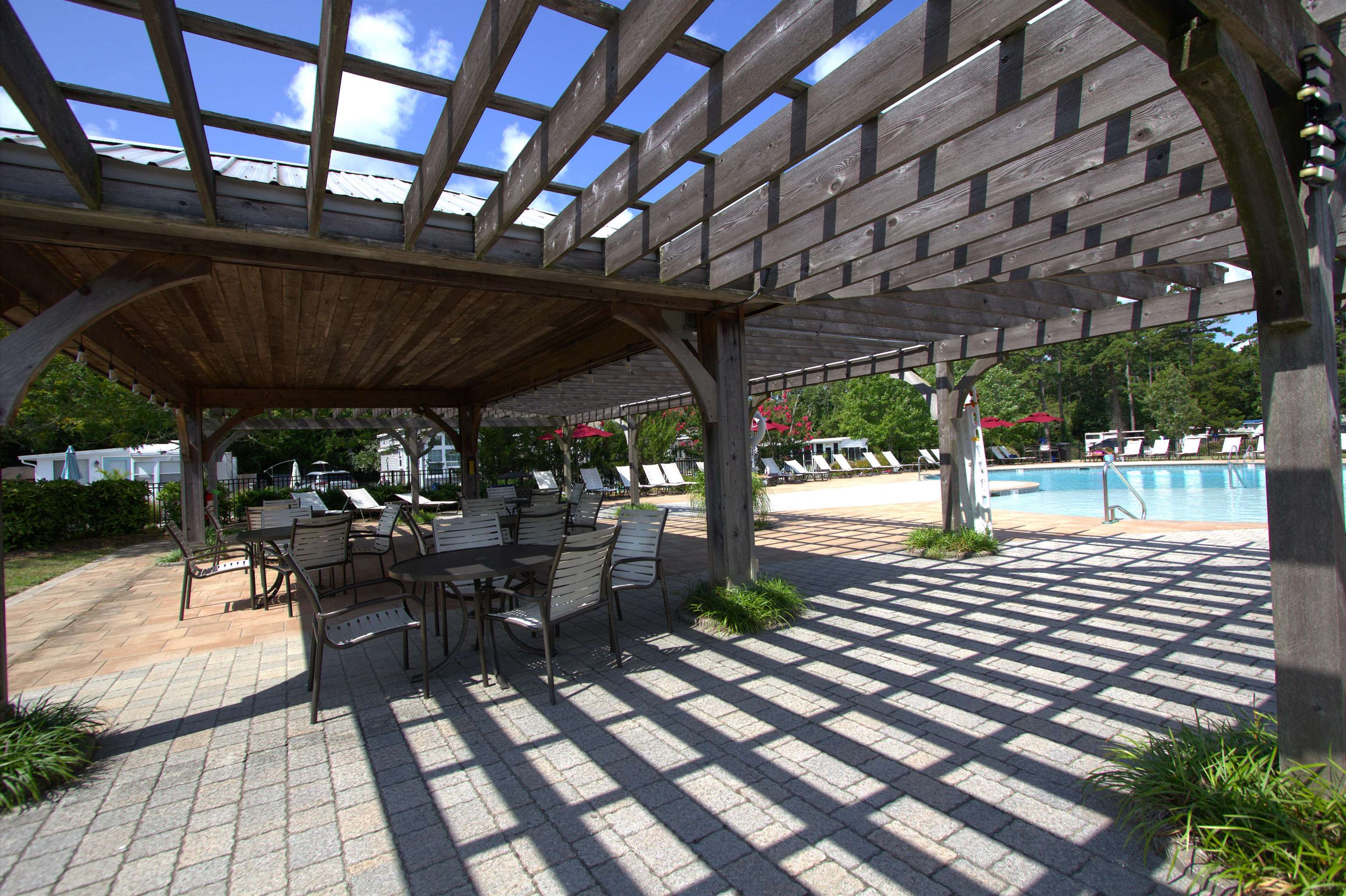 3066 North Rte 9 Ocean View, NJ 08230 - Photo 42 of 49 a view of a patio with table and chairs barbeque potted plants and large tree