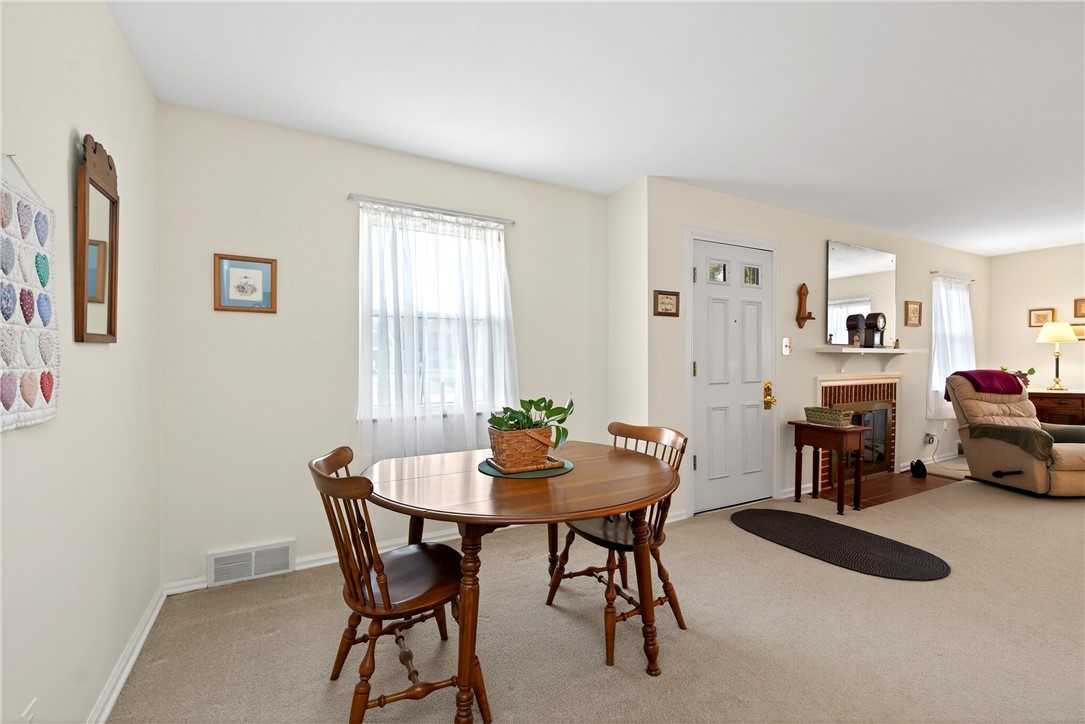 1237 Laurelwood Road Dayton, OH 45409 - Photo 10 of 56 This inviting dining area seamlessly connects to the living room, featuring a fireplace for cozy gatherings.