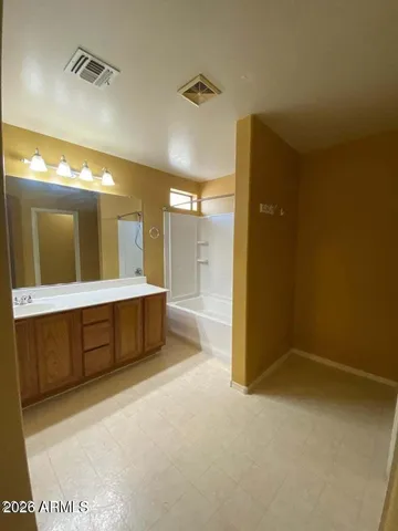 a bathroom with a tub a sink shower and mirror