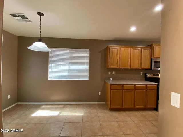 a kitchen with kitchen island a counter top space appliances and a window