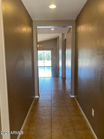 a view of hallway with a door and a rug