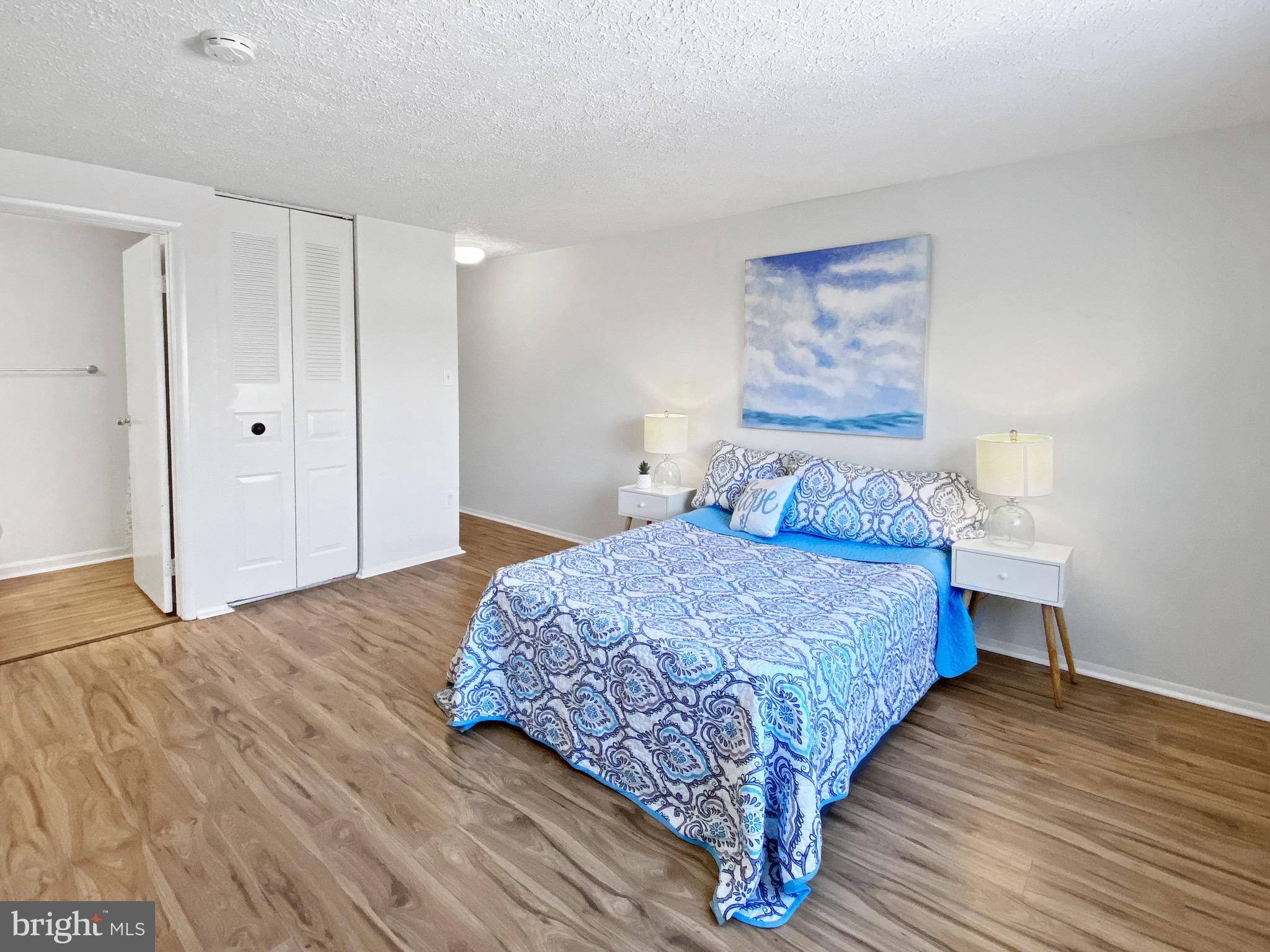 19525 Gunners Branch Road, Unit 222 Germantown, MD 20876 - Photo 10 of 15 a bedroom with a bed and a painting on the wall