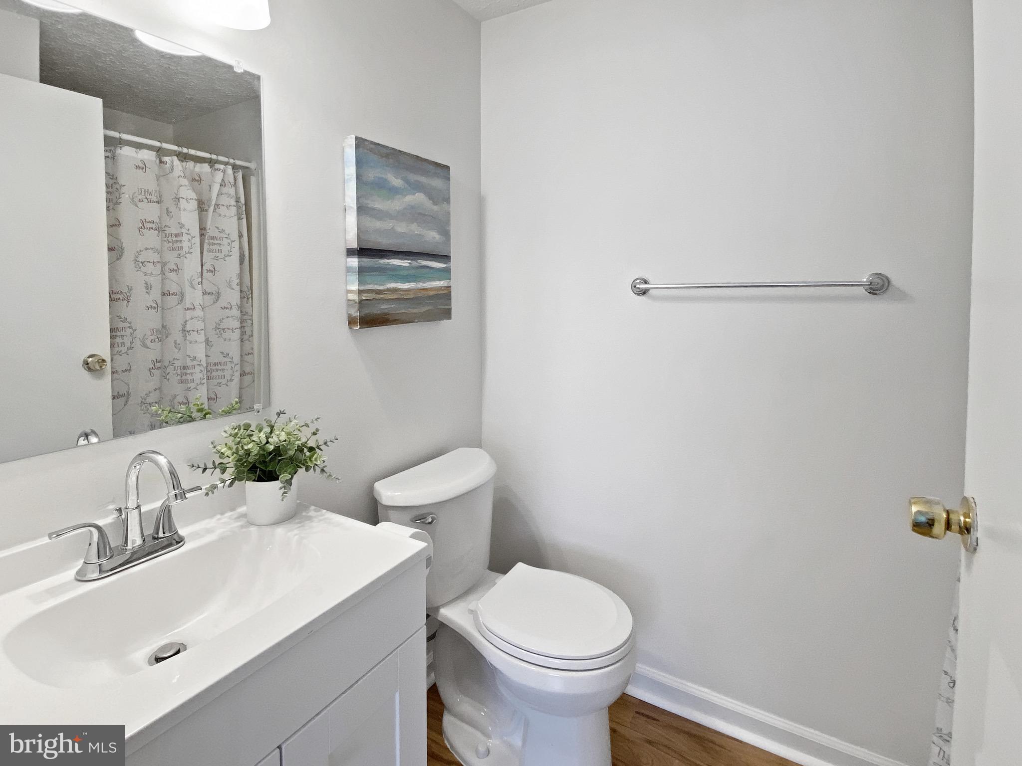 19525 Gunners Branch Road, Unit 222 Germantown, MD 20876 - Photo 11 of 15 a bathroom with a sink mirror and toilet