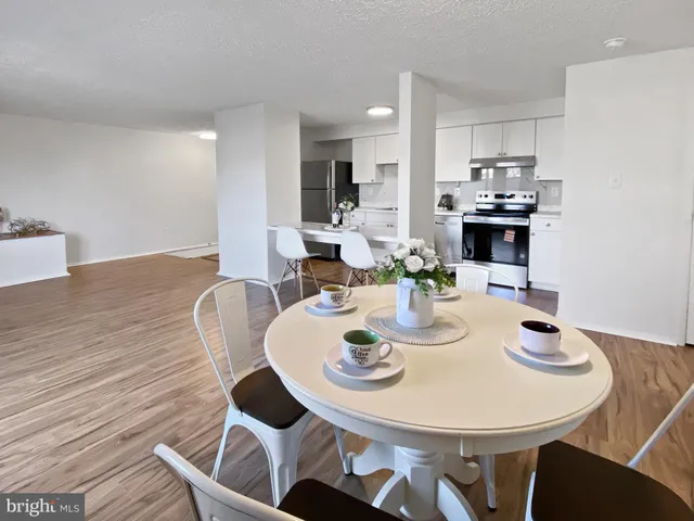 a view of a dining room with furniture and wooden floor