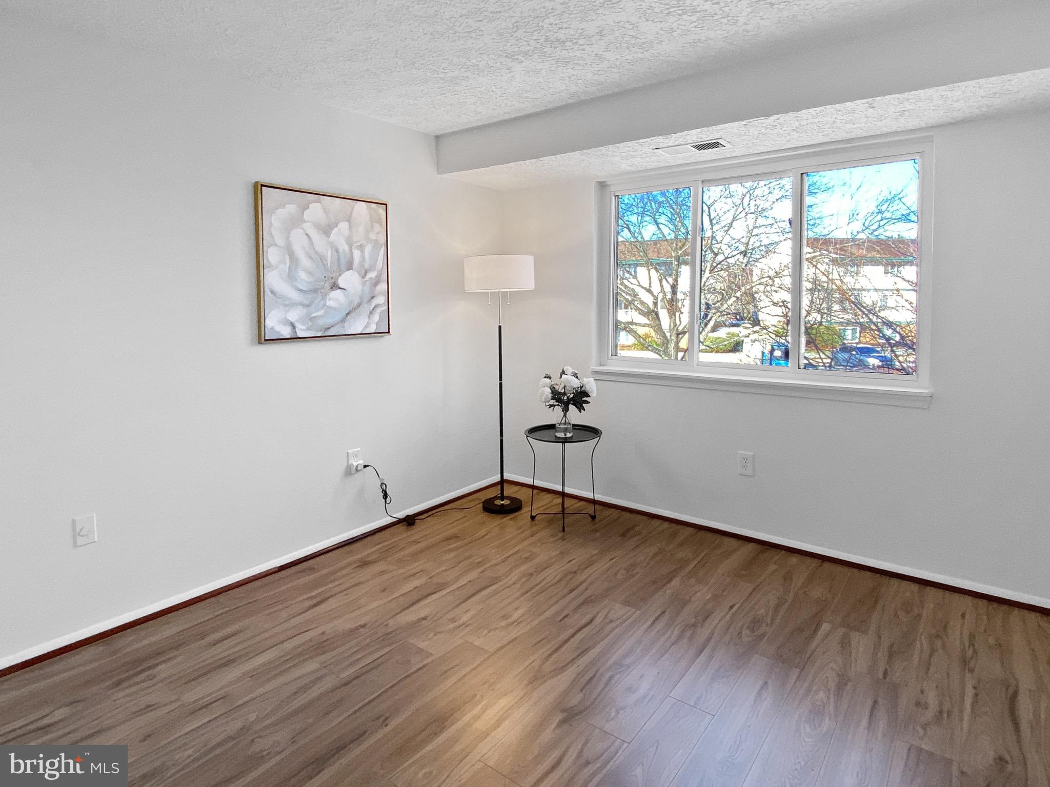 19525 Gunners Branch Road, Unit 222 Germantown, MD 20876 - Photo 7 of 15 a view of empty room with wooden floor and fan