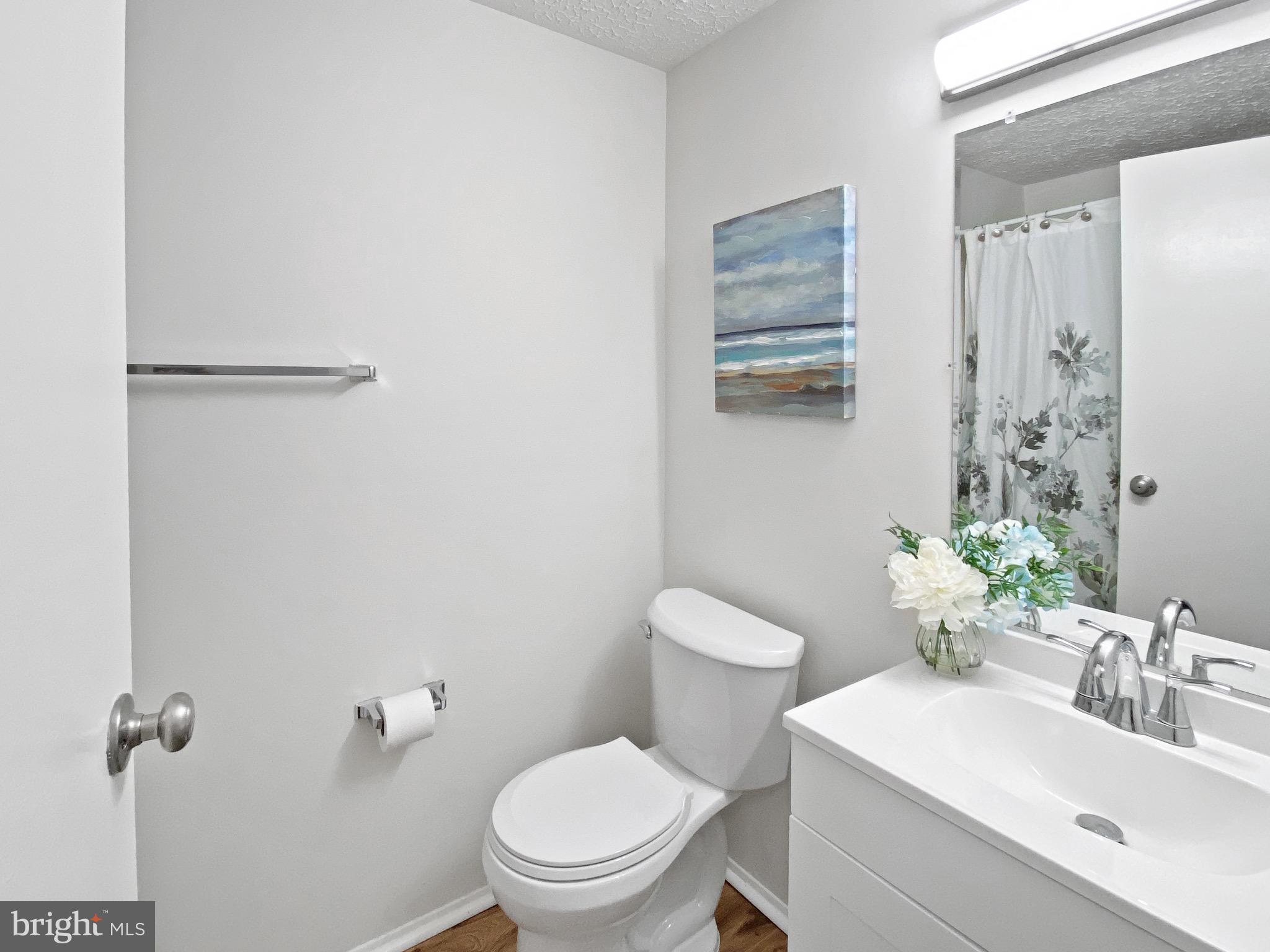 19525 Gunners Branch Road, Unit 222 Germantown, MD 20876 - Photo 8 of 15 a bathroom with a toilet sink and mirror