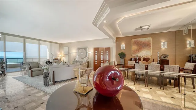 a living room with furniture a flat screen tv and a large window