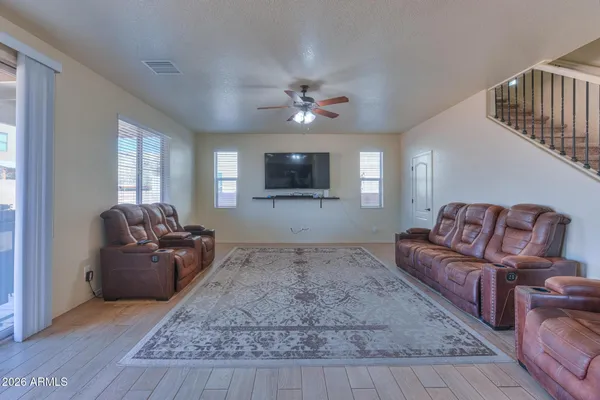 a kitchen with stainless steel appliances granite countertop a stove a sink a refrigerator and a wooden floors
