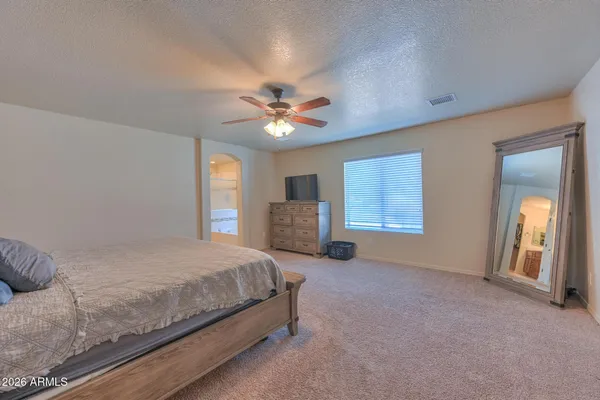 a view of staircase with lots of frames on wall and wooden floor