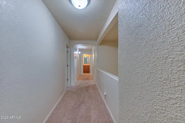a bathroom with double vanity and a mirror