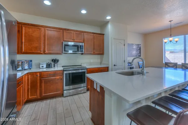 a kitchen with granite countertop a sink and cabinets