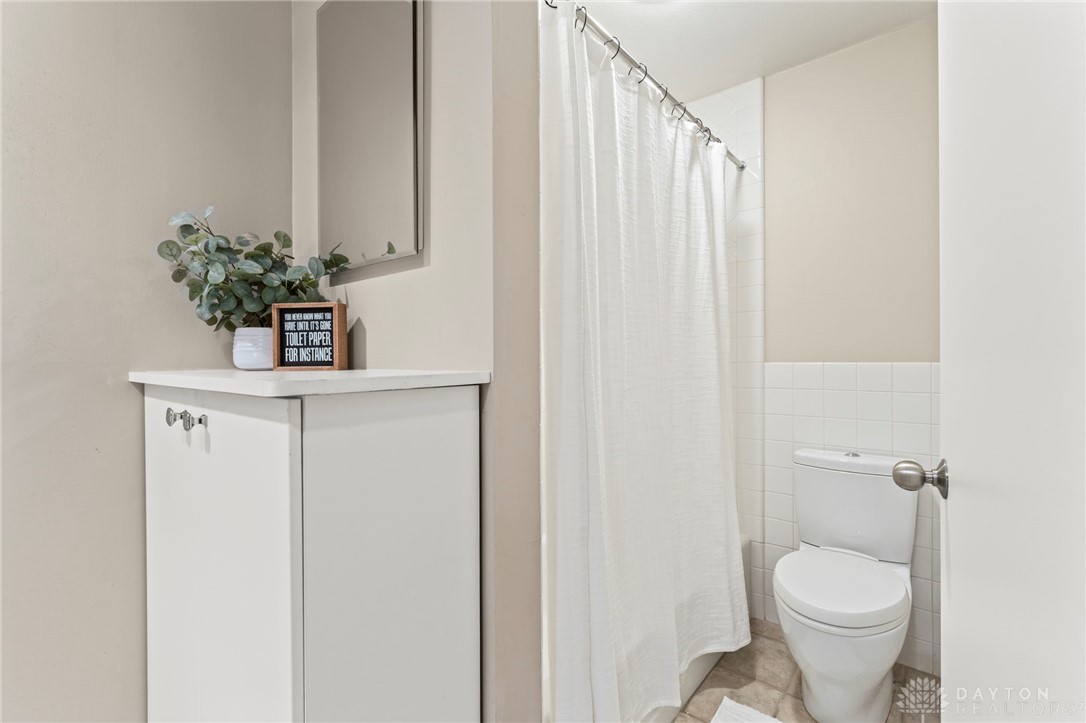 2247 East Whipp Road Dayton, OH 45440 - Photo 34 of 52 This bathroom features a contemporary toilet, functional storage, and convenient shower area.